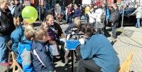 Viele Menschen laufen durch Ibbenbüren. Kinder schauen sich ein Modell von einem Automotor an